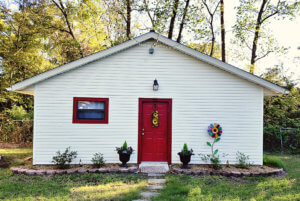 white building with red door